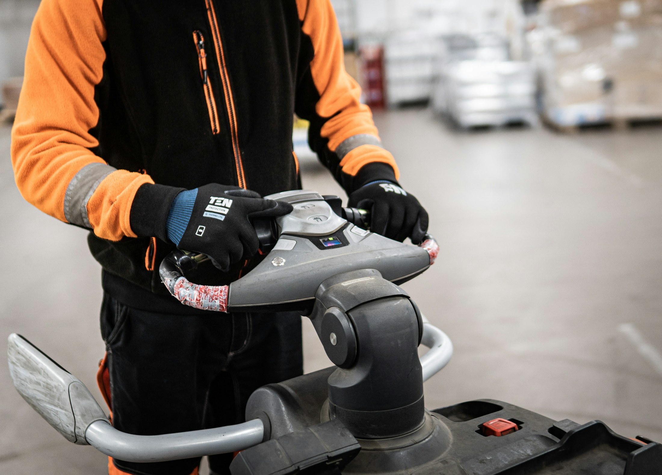 Warehouse worker operating material-handling equipment