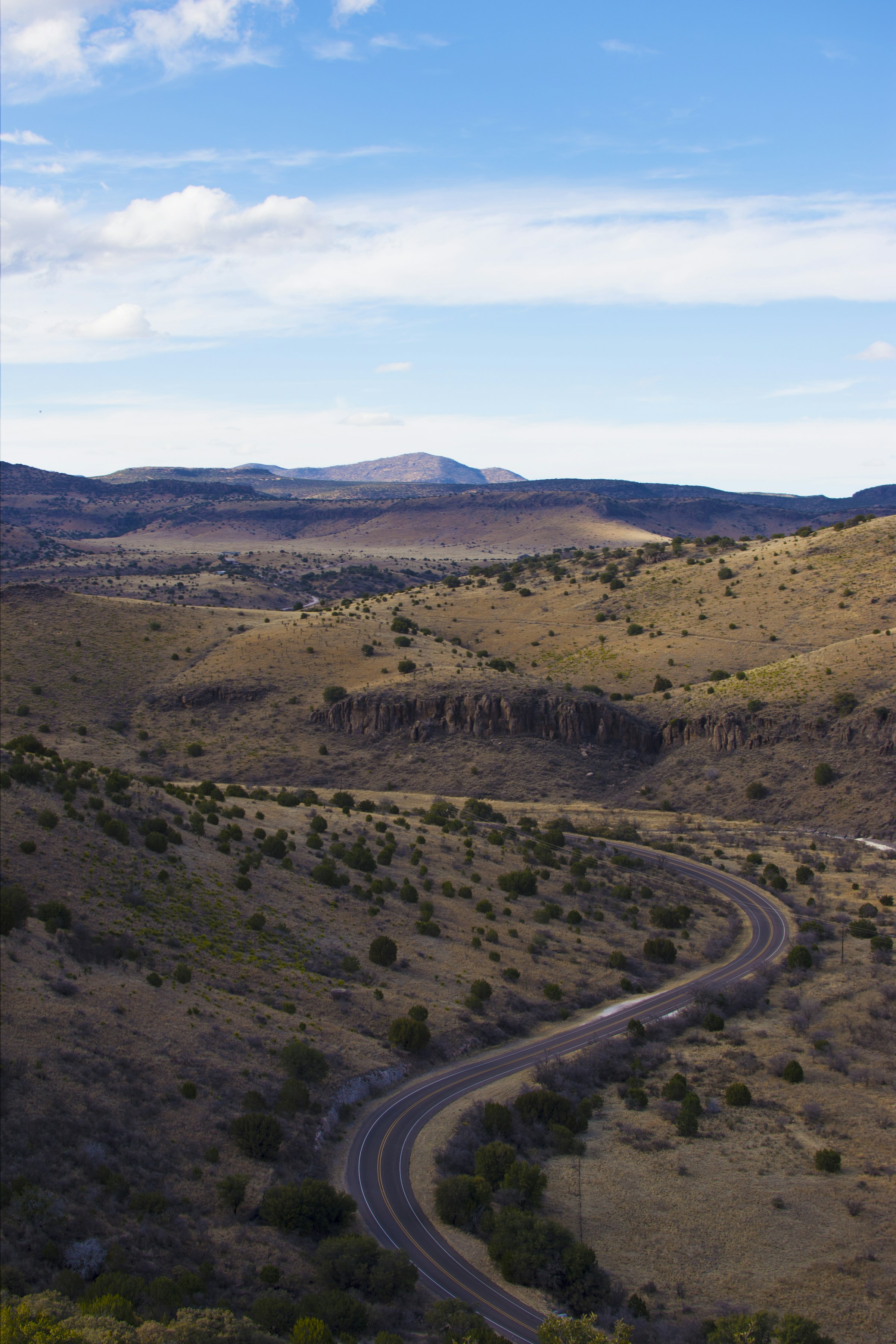 A winding road through a hilly Texas landscape